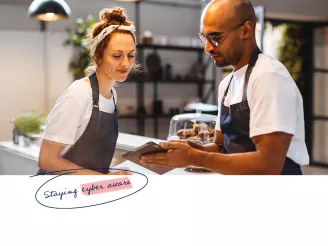 Two hospitality workers using a tablet